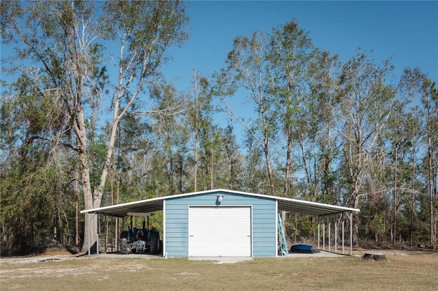 view of outdoor structure with a yard, a carport, and a garage