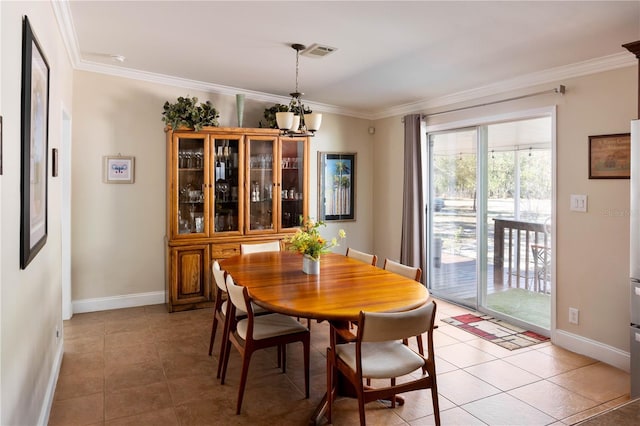 tiled dining area with a notable chandelier and crown molding