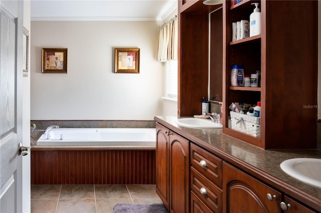 bathroom featuring tile patterned floors, vanity, ornamental molding, and a tub