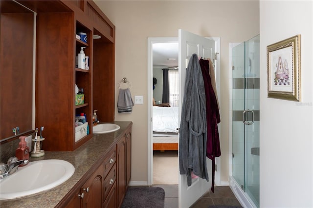 bathroom featuring tile patterned flooring, vanity, and a shower with door