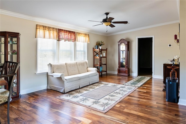 living room featuring dark hardwood / wood-style floors, ceiling fan, and crown molding