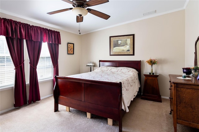 carpeted bedroom featuring ceiling fan and crown molding