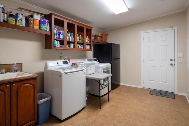 laundry room with sink, ornamental molding, and washing machine and clothes dryer