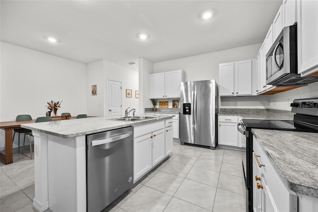 kitchen featuring appliances with stainless steel finishes, a center island with sink, white cabinetry, and sink