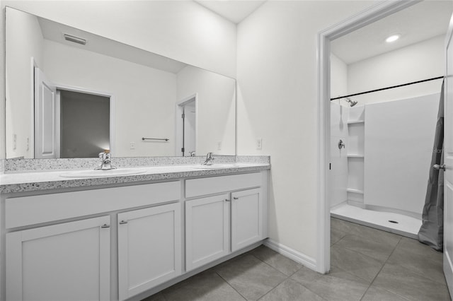 bathroom featuring a shower and vanity