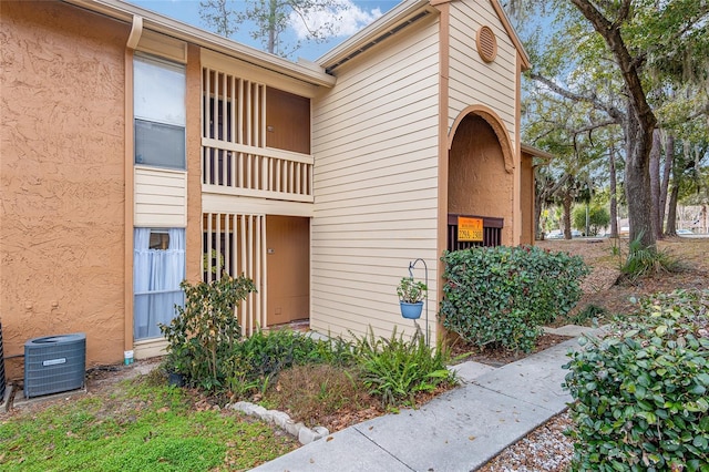 doorway to property featuring a balcony and central AC