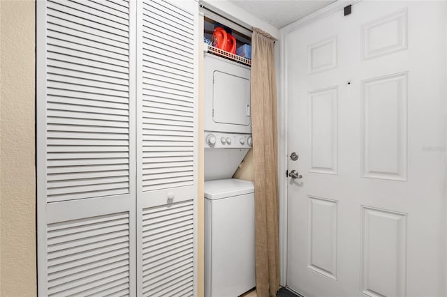 laundry area featuring stacked washer and clothes dryer