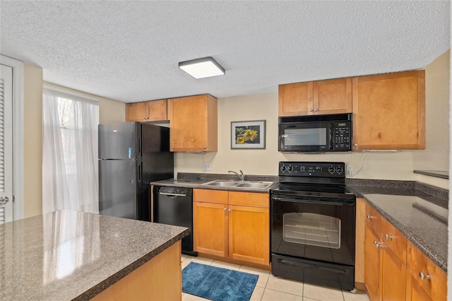 kitchen featuring sink, light tile patterned floors, a textured ceiling, and black appliances