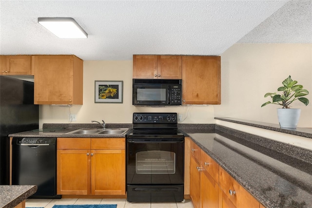 kitchen with sink, light tile patterned floors, a textured ceiling, and black appliances