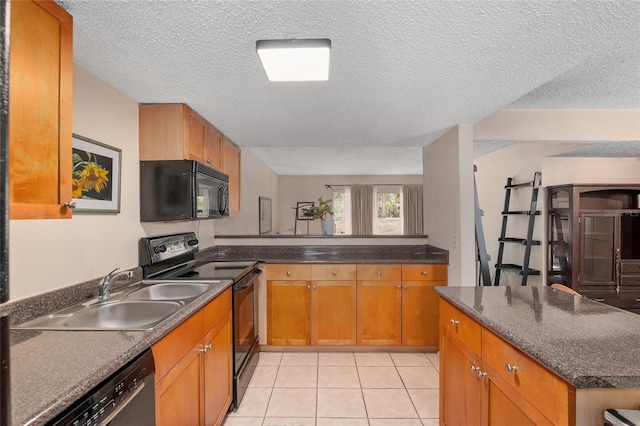 kitchen featuring sink, light tile patterned floors, black appliances, a textured ceiling, and kitchen peninsula