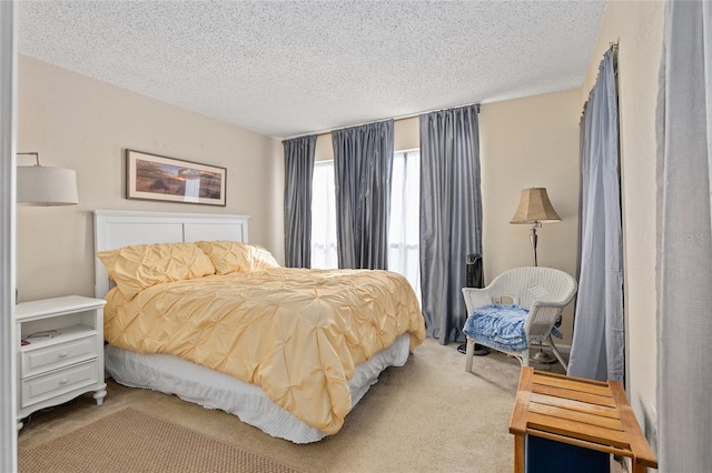 bedroom with light carpet and a textured ceiling