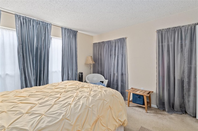 bedroom featuring carpet and a textured ceiling