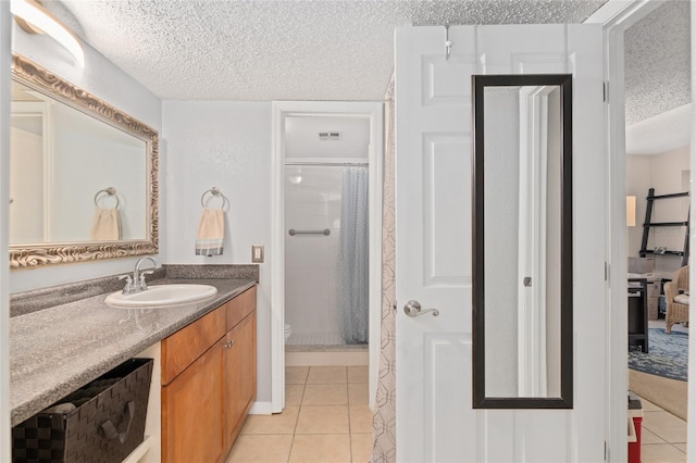 bathroom featuring tile patterned floors, toilet, a textured ceiling, and a shower with shower curtain