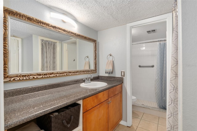 bathroom with vanity, toilet, tile patterned floors, a textured ceiling, and a shower with curtain