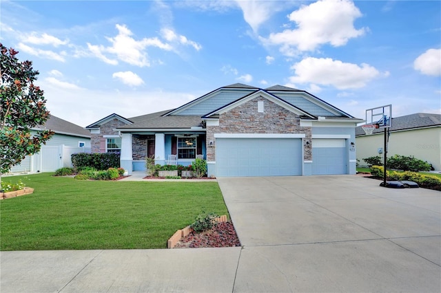 view of front of house with covered porch, a garage, and a front yard