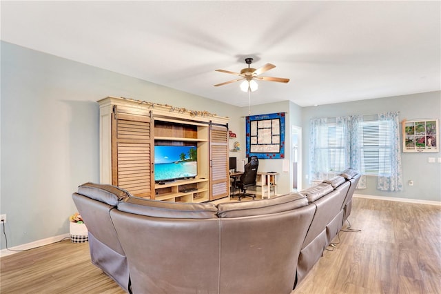 living room featuring ceiling fan and light wood-type flooring