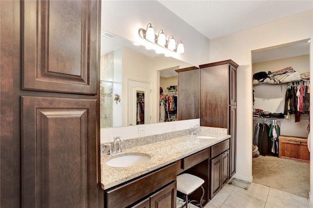 bathroom with tile patterned flooring and vanity