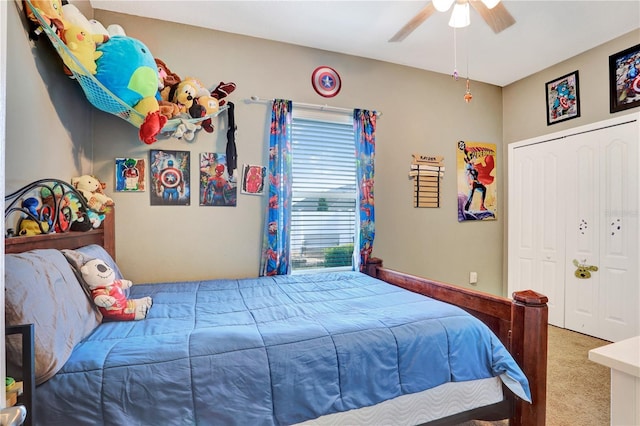 carpeted bedroom featuring ceiling fan and a closet