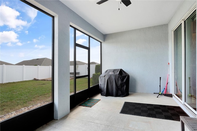 sunroom featuring ceiling fan and a healthy amount of sunlight