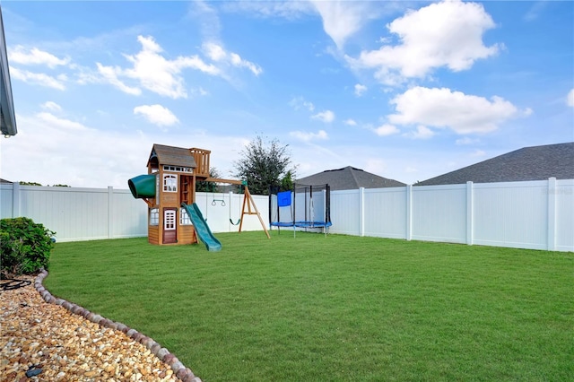 view of jungle gym featuring a trampoline and a lawn