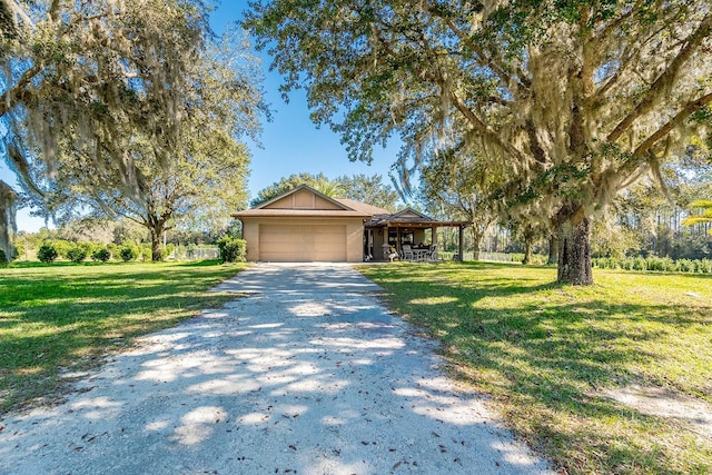 view of front of property featuring a garage and a front yard