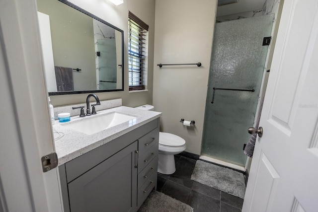 bathroom with vanity, toilet, and a shower