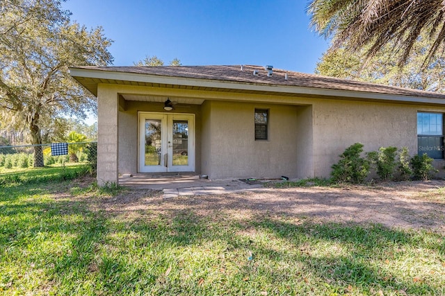 back of house with ceiling fan and french doors