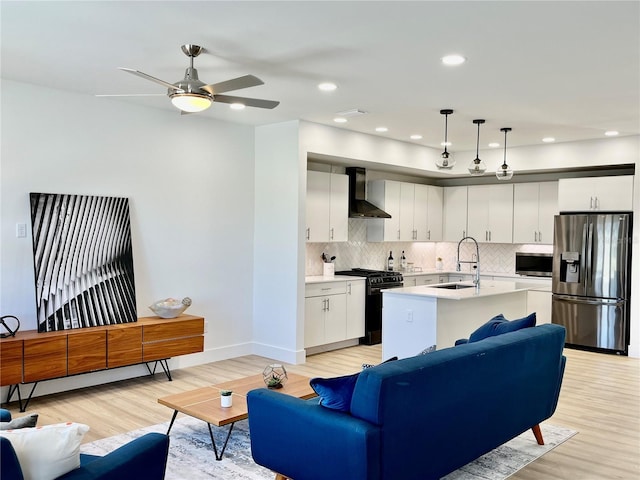 interior space with ceiling fan, light wood-type flooring, and sink