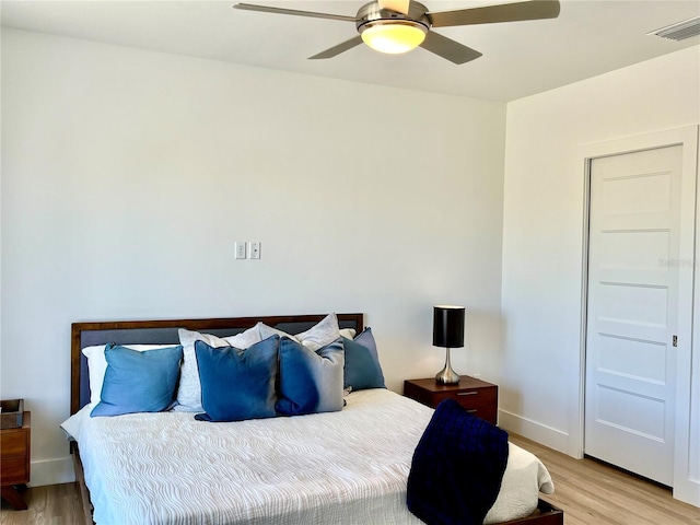 bedroom with light wood-type flooring and ceiling fan