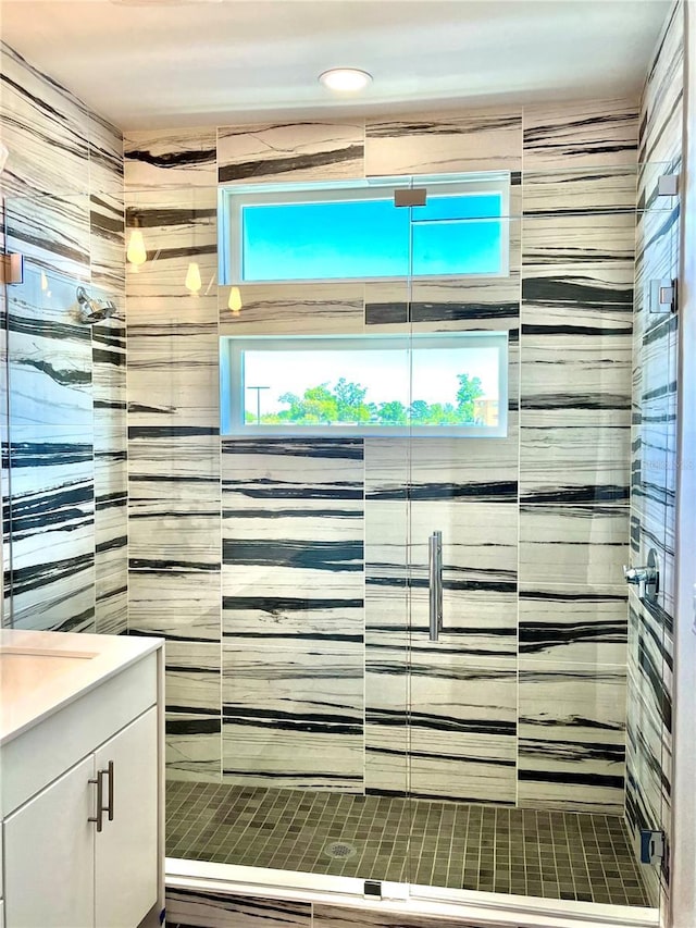 bathroom with vanity and a shower with shower door