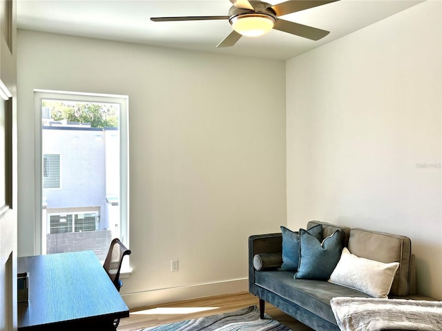 home office with hardwood / wood-style flooring and ceiling fan