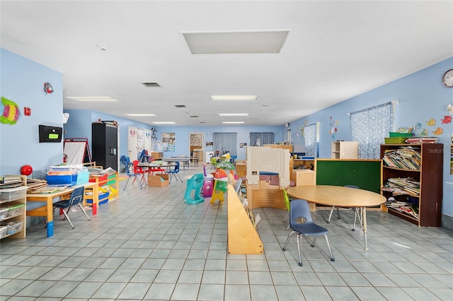 recreation room with light tile patterned flooring