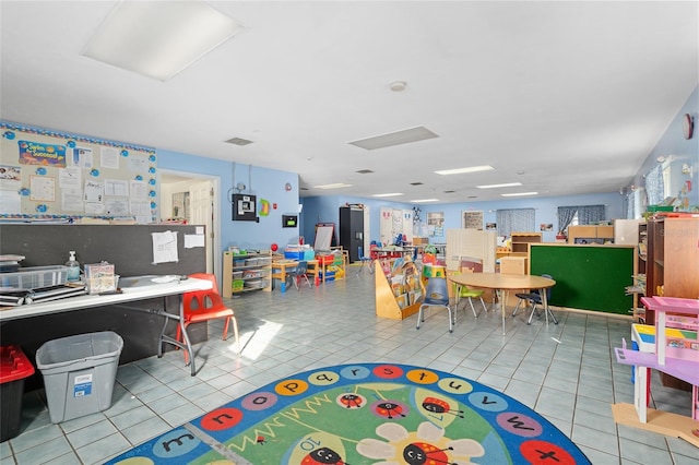 recreation room with light tile patterned flooring