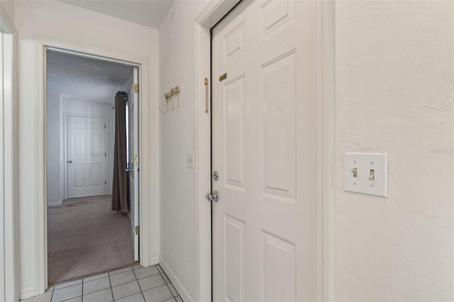 corridor with light tile patterned flooring