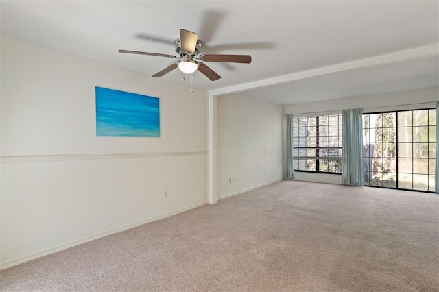 unfurnished room with light colored carpet and ceiling fan