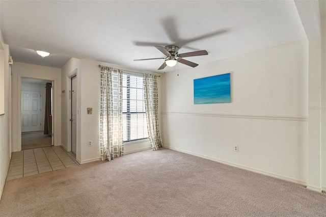 carpeted spare room with ceiling fan