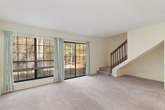 unfurnished living room featuring carpet flooring