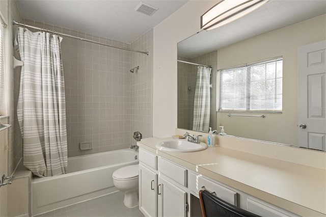 full bathroom with tile patterned flooring, vanity, shower / bathtub combination with curtain, and toilet