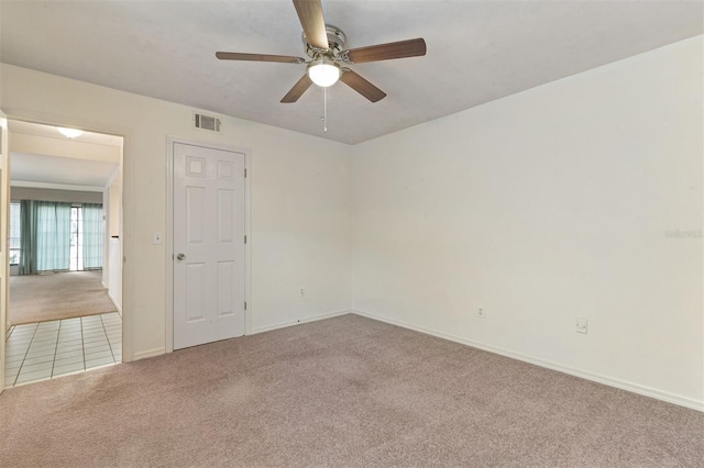 empty room with light carpet and ceiling fan