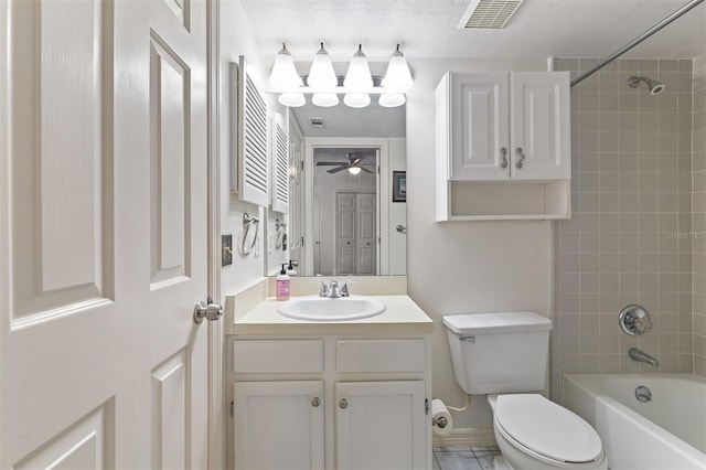 full bathroom with ceiling fan, vanity, toilet, and tiled shower / bath combo