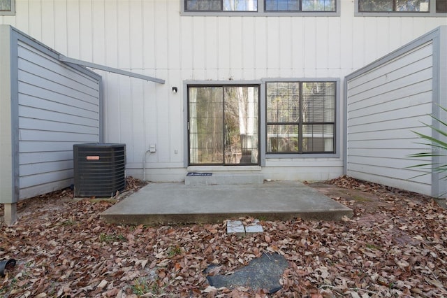 property entrance featuring cooling unit and a patio