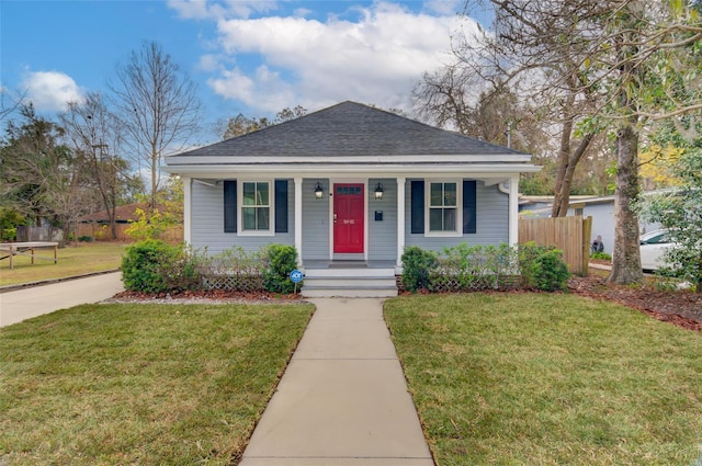 bungalow featuring a porch and a front lawn