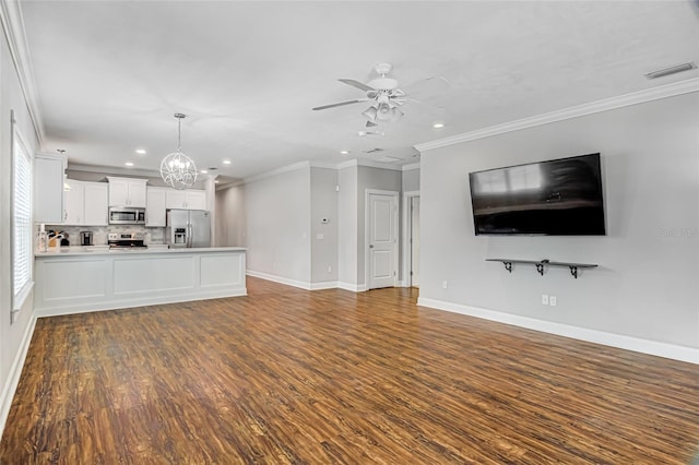 unfurnished living room with ceiling fan with notable chandelier, dark hardwood / wood-style floors, and ornamental molding