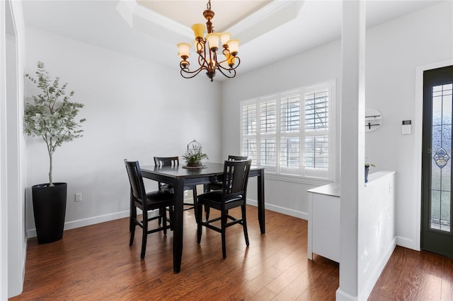 dining area featuring a wall mounted air conditioner, dark hardwood / wood-style flooring, a raised ceiling, and a chandelier