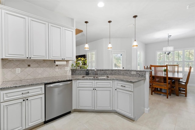 kitchen with tasteful backsplash, white cabinetry, sink, and stainless steel dishwasher