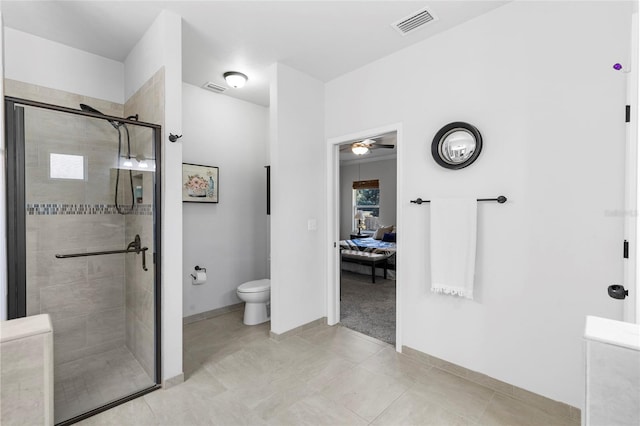 bathroom with toilet, a shower with door, and ceiling fan