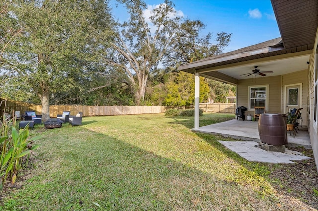 view of yard with ceiling fan, an outdoor living space, and a patio