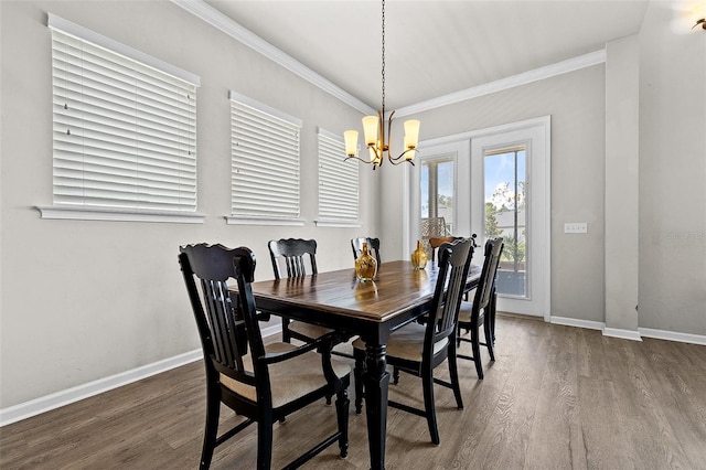 dining room with hardwood / wood-style flooring, french doors, crown molding, and a chandelier