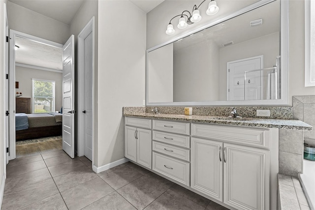 bathroom with vanity, tile patterned floors, and a shower with shower door