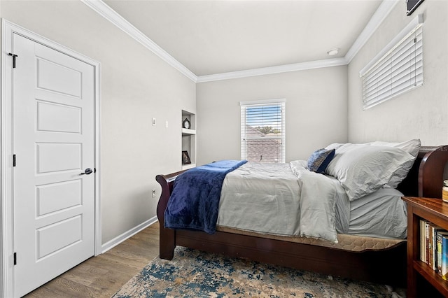 bedroom with wood-type flooring and ornamental molding